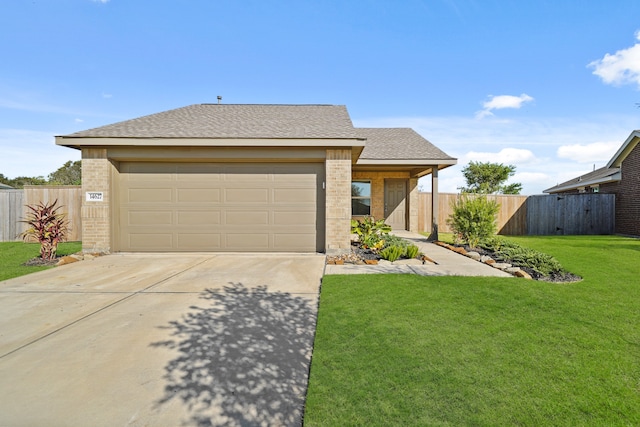 view of front of property featuring a front lawn and a garage