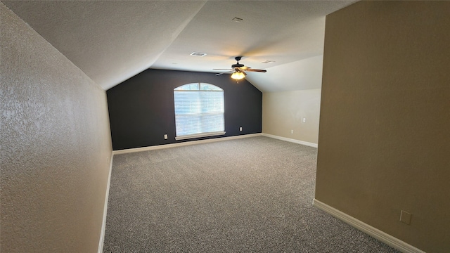 bonus room featuring carpet, vaulted ceiling, a textured ceiling, and ceiling fan