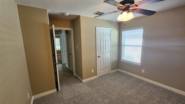 unfurnished bedroom featuring a closet, ceiling fan, and carpet flooring