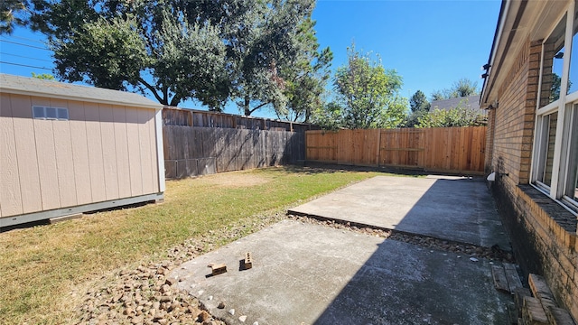 view of yard with a shed and a patio