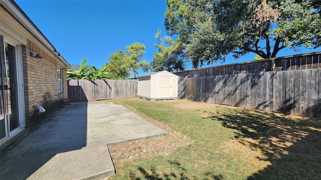 view of yard with a patio area and a storage shed