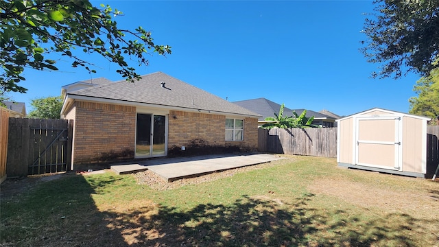 rear view of property with a storage shed, a yard, and a patio