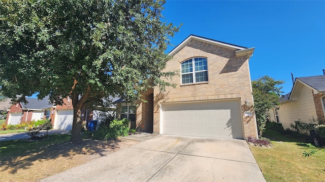 view of front of property featuring a front lawn and a garage