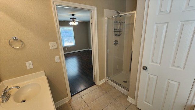 bathroom featuring walk in shower, hardwood / wood-style flooring, sink, and ceiling fan