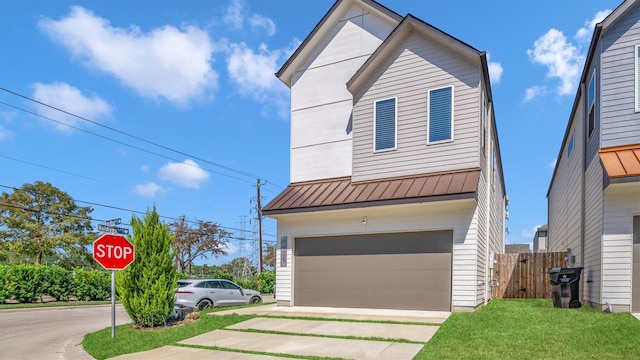 view of front facade with a garage and a front lawn