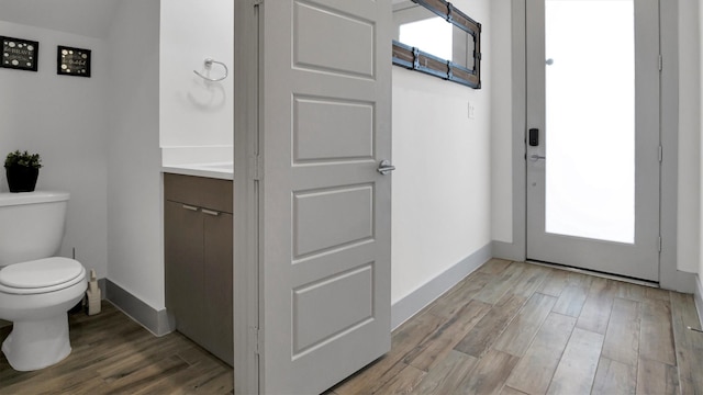 bathroom with vanity, hardwood / wood-style floors, and toilet