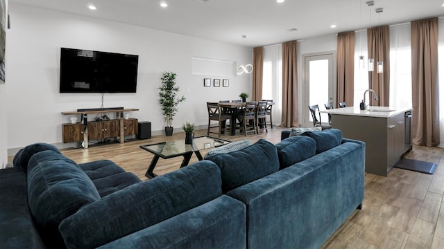 living room with sink and light hardwood / wood-style floors