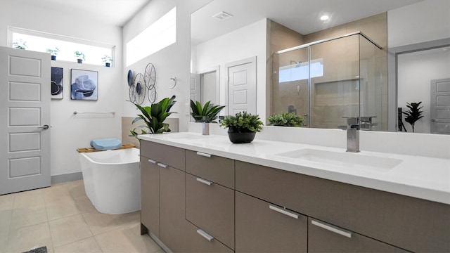 bathroom featuring tile patterned flooring, vanity, and separate shower and tub