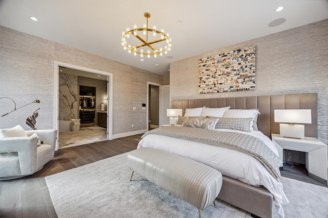 bedroom featuring dark hardwood / wood-style flooring and an inviting chandelier