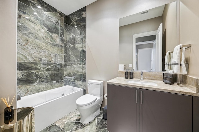 full bathroom featuring vanity, toilet, and bath / shower combo with glass door