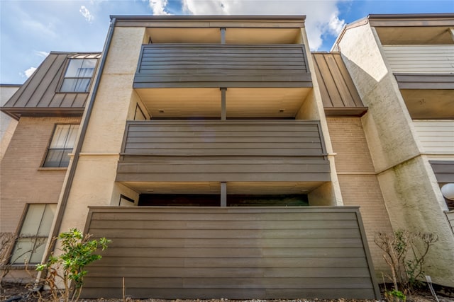 back of house featuring a balcony