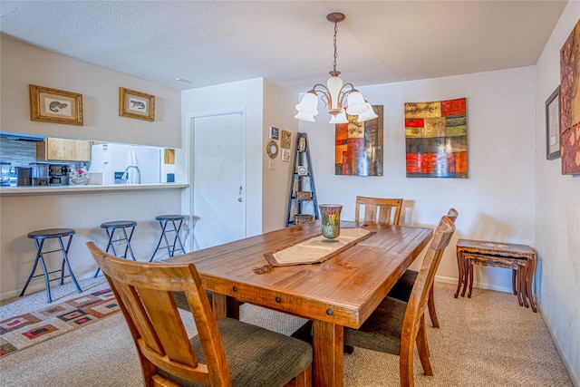 carpeted dining space with a textured ceiling and a notable chandelier