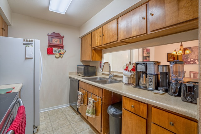 kitchen with stainless steel appliances, a chandelier, and sink