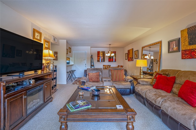 living room featuring a notable chandelier and carpet floors