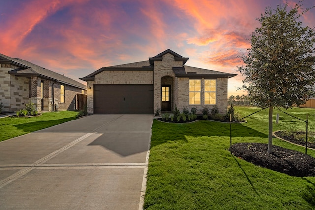 view of front of house with a garage and a yard