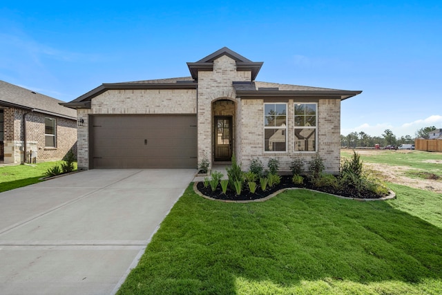 view of front of home with a front yard and a garage