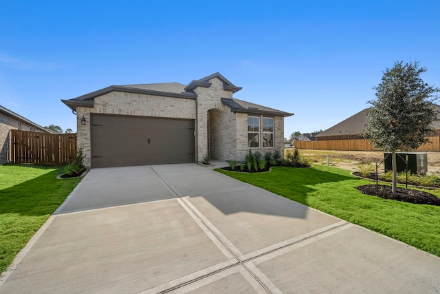 view of front of property with a front yard and a garage