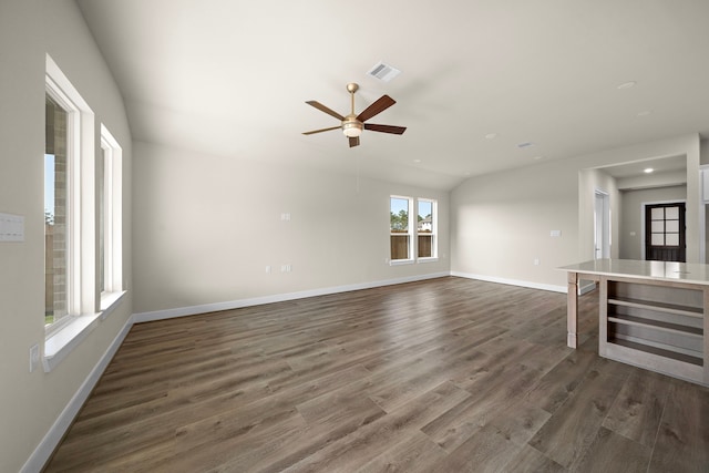 unfurnished living room with ceiling fan and dark hardwood / wood-style flooring