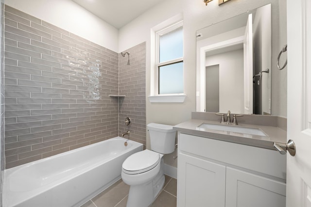 full bathroom featuring tiled shower / bath, tile patterned floors, vanity, and toilet