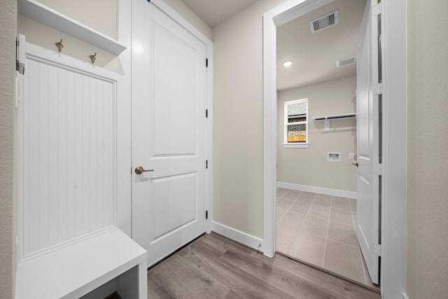 mudroom with light hardwood / wood-style floors