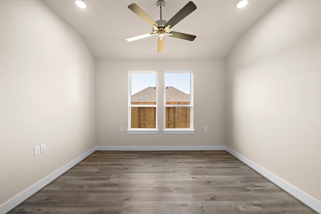 spare room featuring ceiling fan, vaulted ceiling, and wood-type flooring