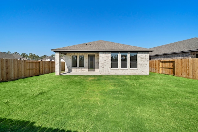 back of house featuring a yard and a patio area