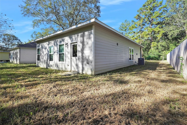 view of property exterior featuring a yard and central AC