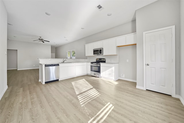 kitchen featuring sink, white cabinets, light hardwood / wood-style flooring, appliances with stainless steel finishes, and ceiling fan