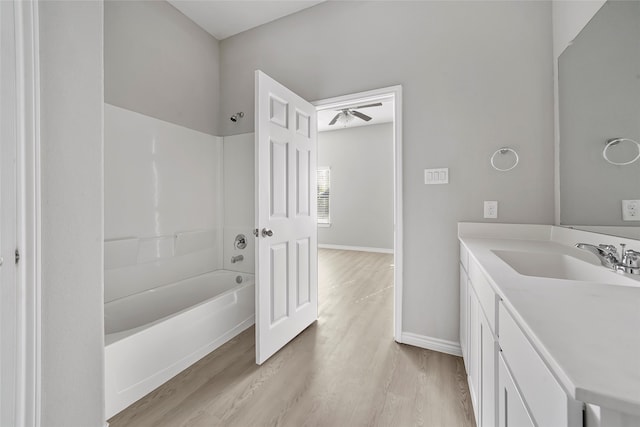 bathroom featuring shower / bathtub combination, vanity, ceiling fan, and hardwood / wood-style flooring