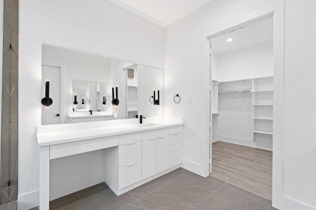 bathroom with hardwood / wood-style floors, an enclosed shower, and vanity