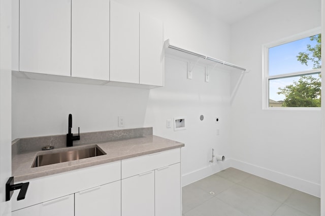 clothes washing area featuring sink, hookup for an electric dryer, hookup for a gas dryer, cabinets, and hookup for a washing machine