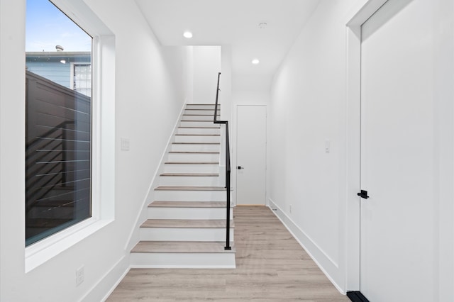 stairway with hardwood / wood-style flooring