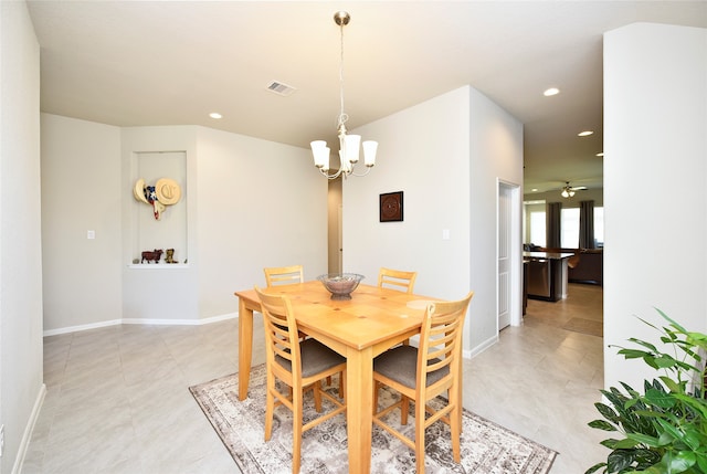 dining area with ceiling fan with notable chandelier