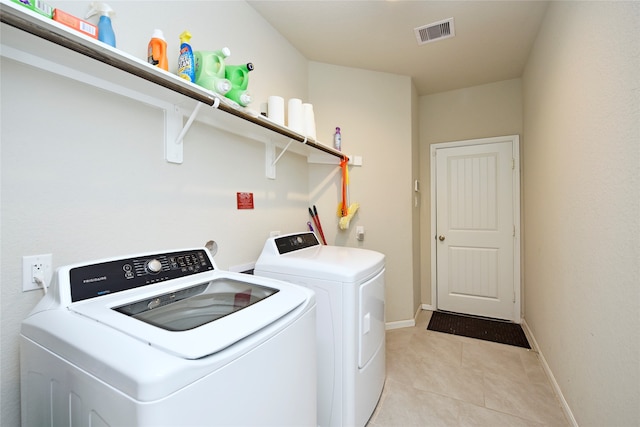 laundry area featuring independent washer and dryer and light tile patterned floors