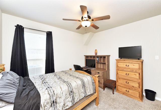 bedroom with ceiling fan and light carpet