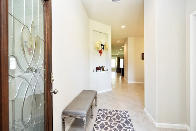 hall featuring light tile patterned flooring