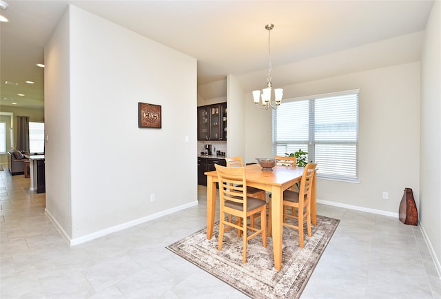 dining space featuring a chandelier and a healthy amount of sunlight