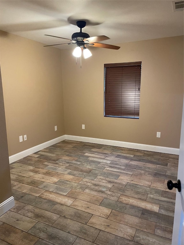 empty room featuring ceiling fan and dark wood-type flooring