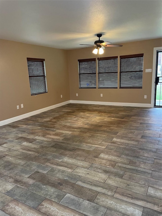 spare room featuring ceiling fan and dark hardwood / wood-style flooring