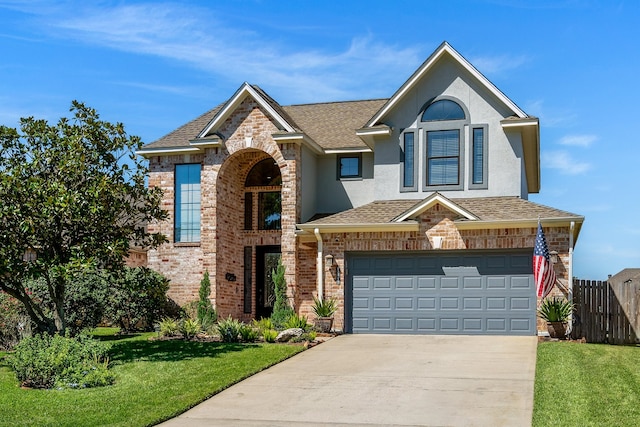 view of property with a front lawn and a garage