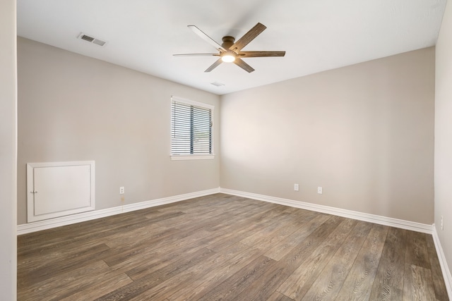 empty room featuring ceiling fan and dark wood-type flooring