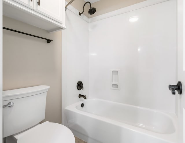 bathroom featuring bathtub / shower combination and toilet