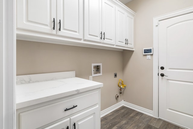 laundry area featuring washer hookup, dark wood-type flooring, hookup for an electric dryer, cabinets, and gas dryer hookup