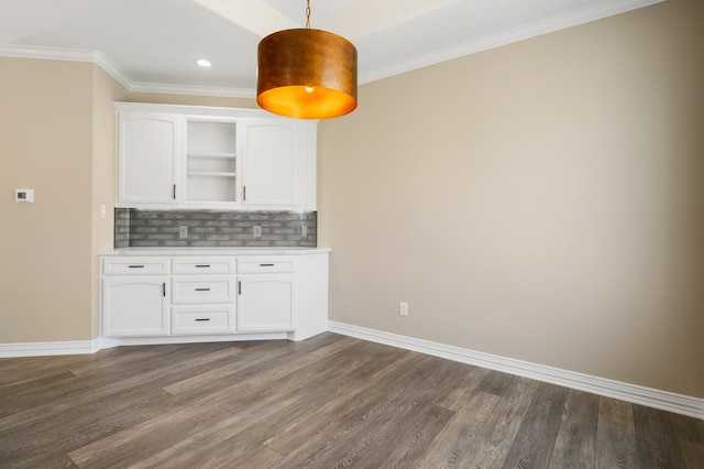 kitchen with decorative backsplash, white cabinetry, dark wood-type flooring, and pendant lighting