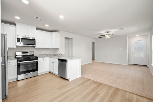 kitchen with ceiling fan, sink, white cabinets, and stainless steel appliances