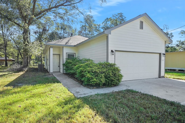 ranch-style house featuring a front lawn, central air condition unit, and a garage