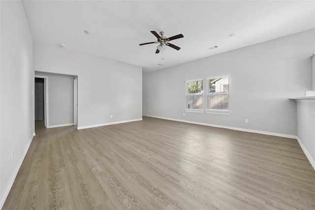 unfurnished living room with a ceiling fan, visible vents, light wood finished floors, and baseboards