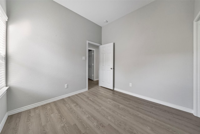 unfurnished bedroom featuring baseboards and wood finished floors