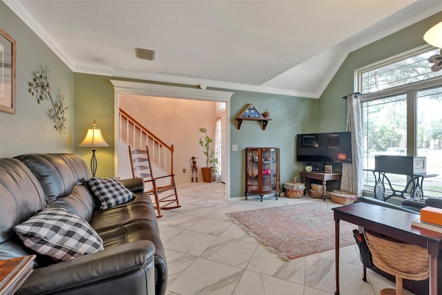 living room with ornamental molding and lofted ceiling