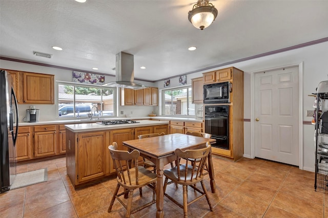 kitchen featuring island exhaust hood, plenty of natural light, a center island, and black appliances